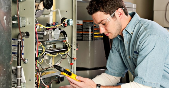technician adjusting furnace