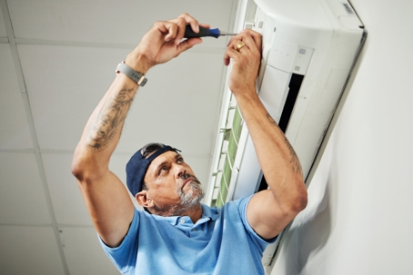 AC technician checking the unit